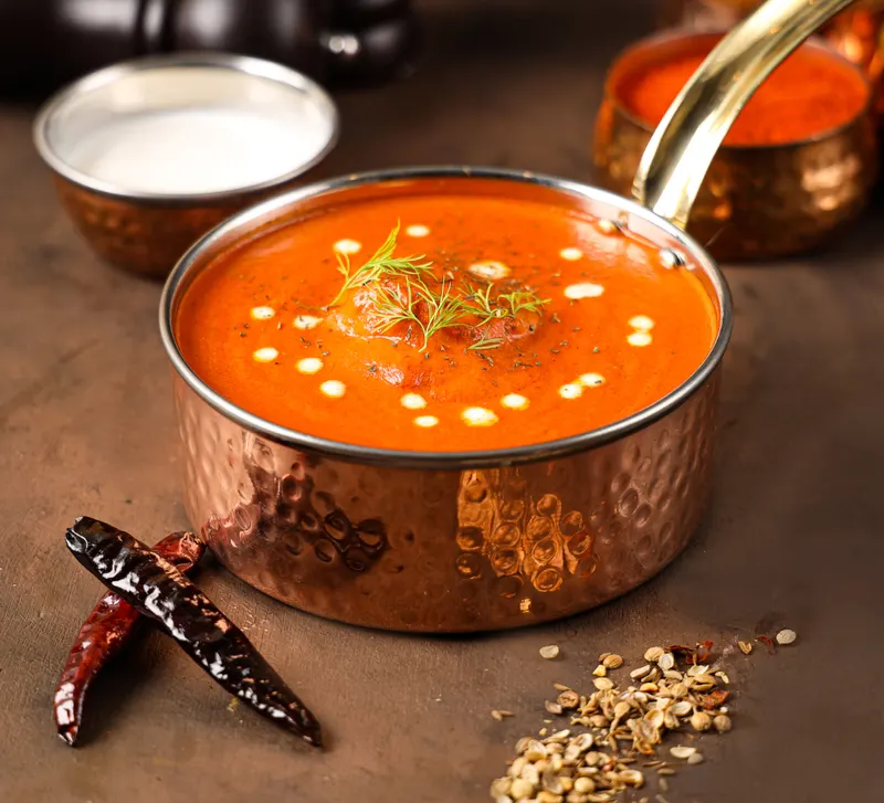 Butter chicken in a copper pot
